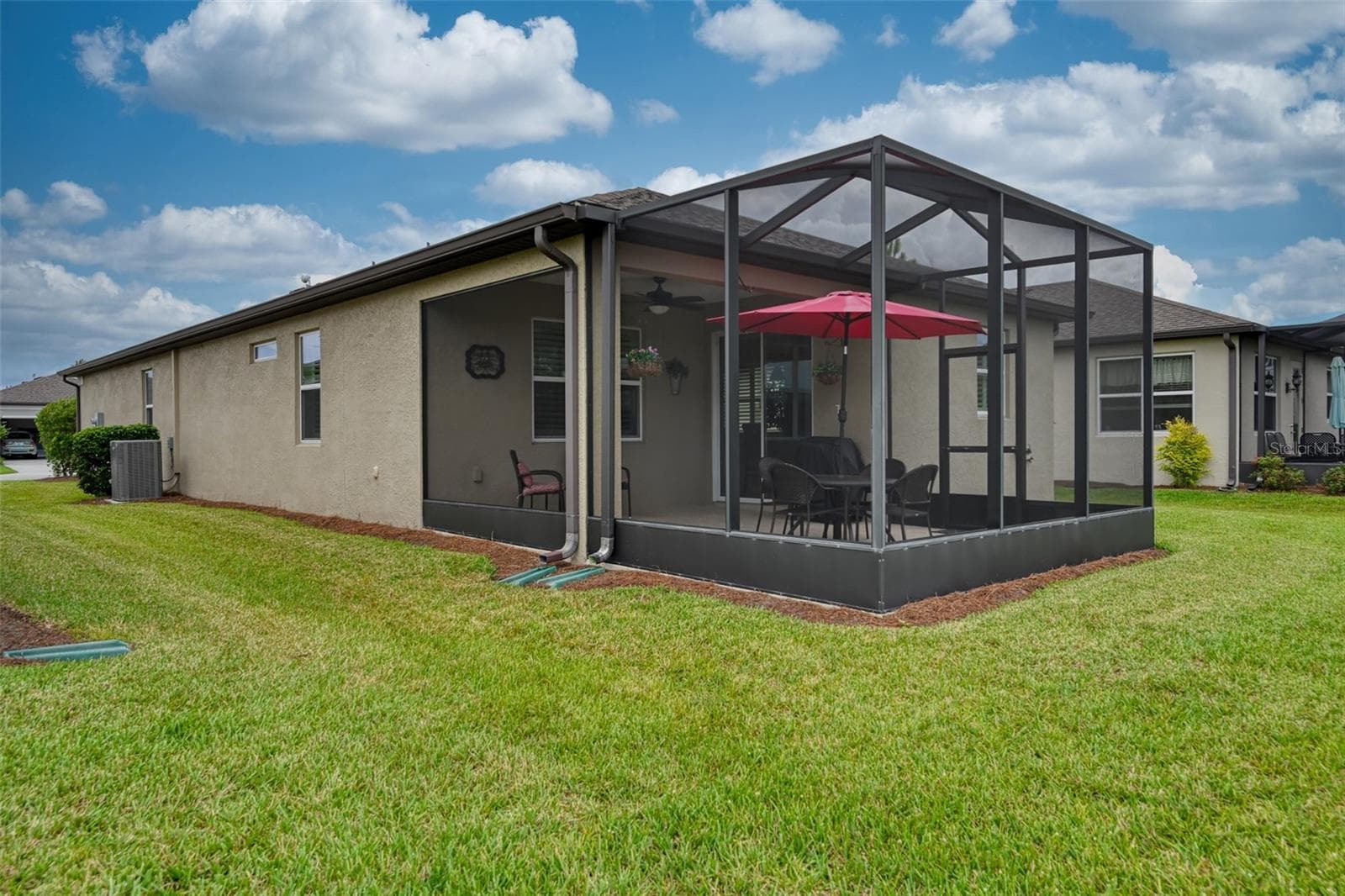 Rear view of home & screened lanai w/cage - 5995 SW 93RD CIR, OCALA