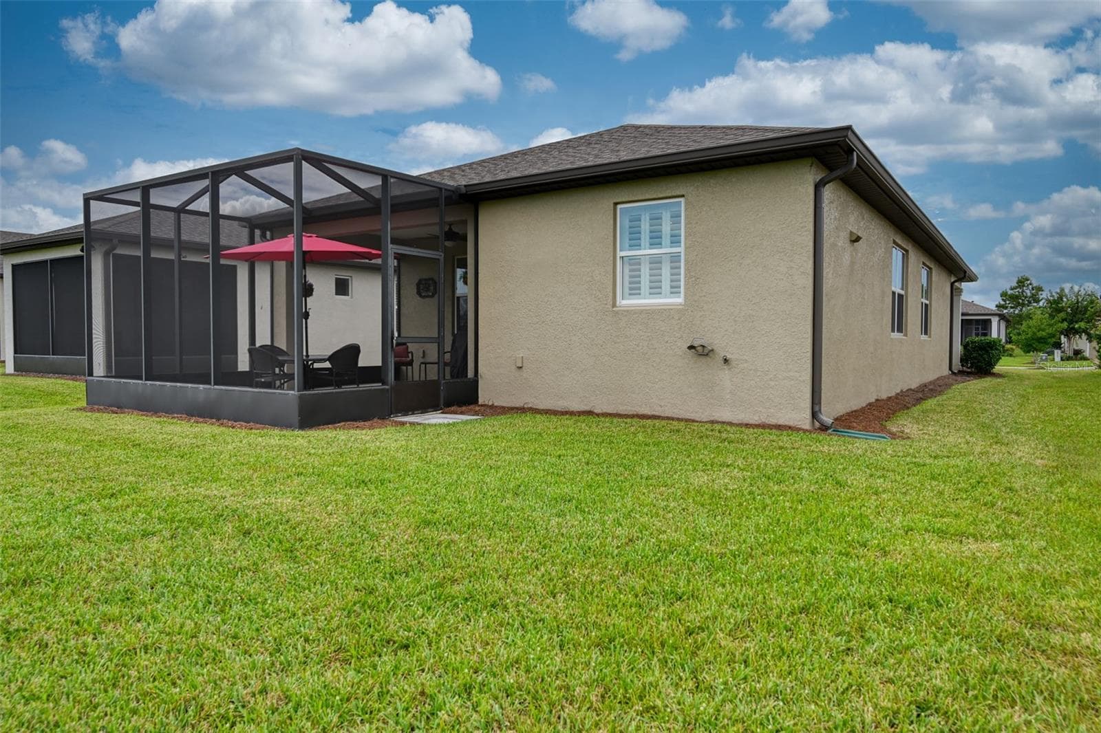 Rear view of home & screened lanai w/cage - 5995 SW 93RD CIR, OCALA