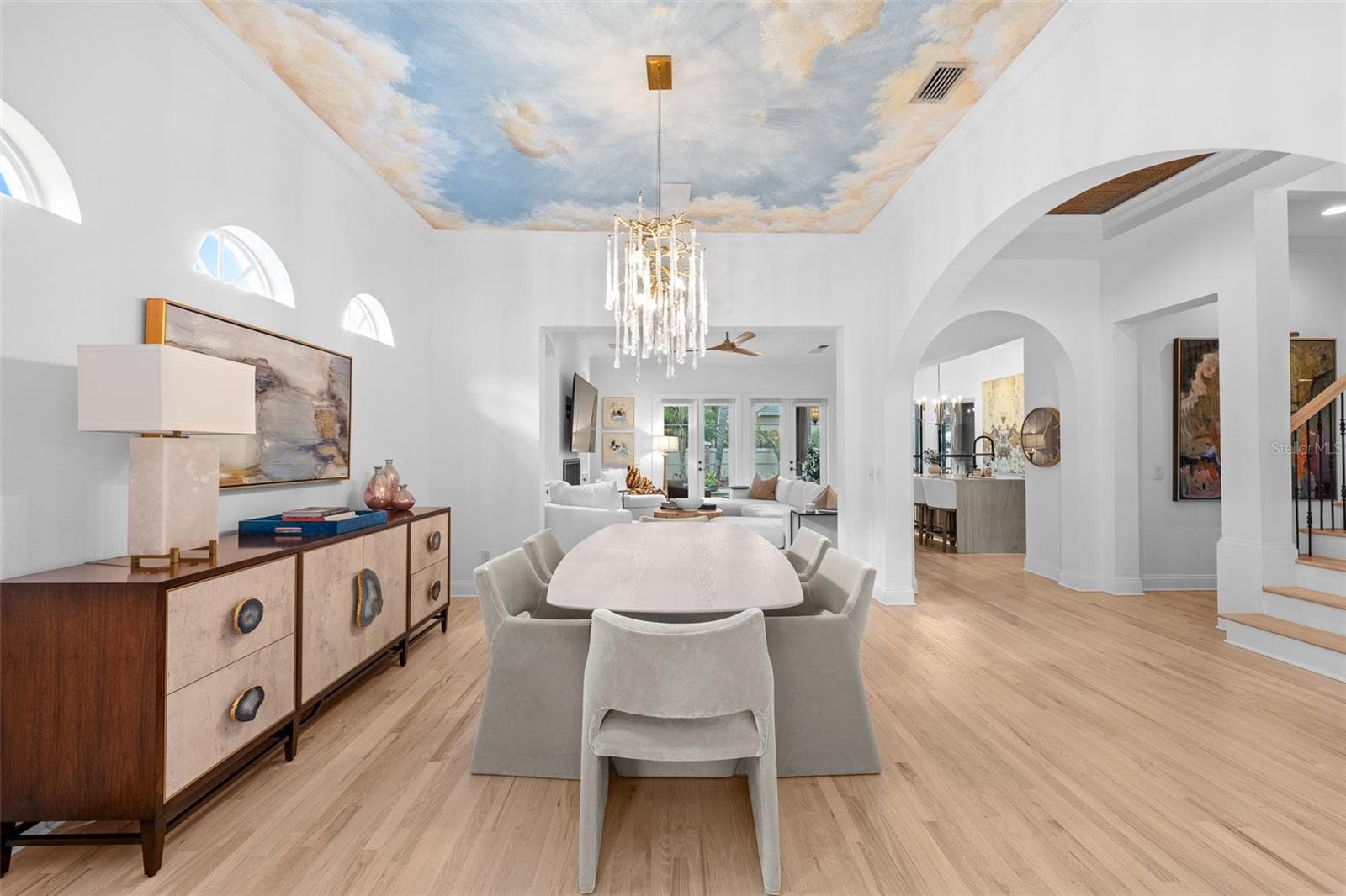Dining area with arched windows and a sightline through to the kitchen and family room. - 1921 FLORESTA VIEW DR, TAMPA
