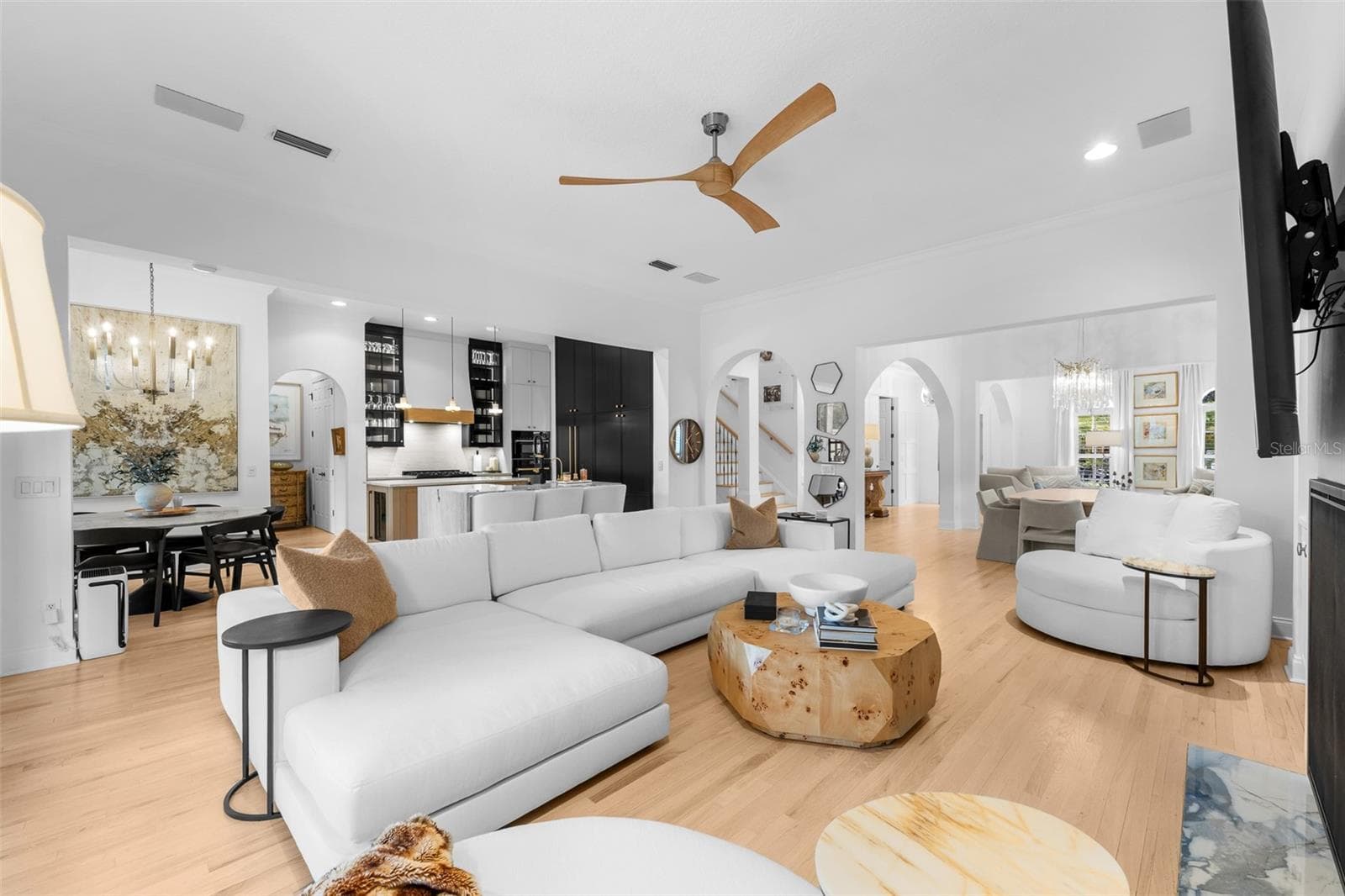 Open family room with ceiling fan, French doors to the lanai, and direct connection to the kitchen. - 1921 FLORESTA VIEW DR, TAMPA
