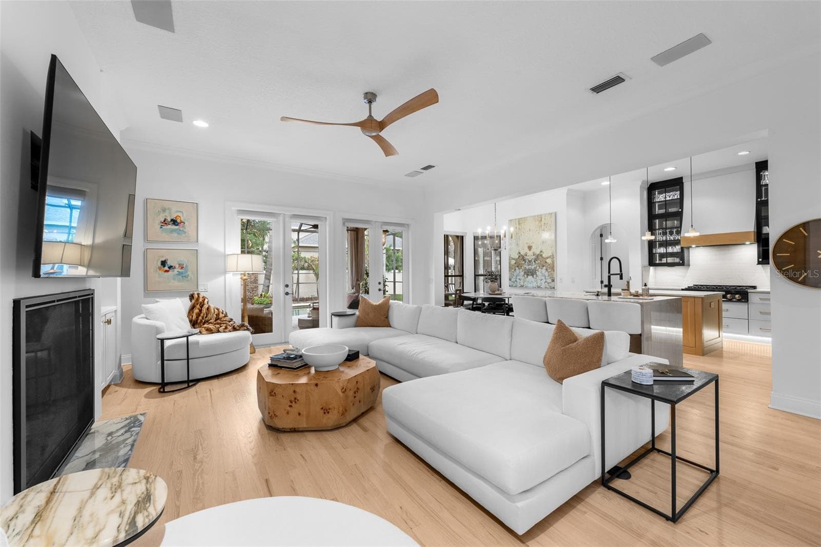 Open-concept family room with fireplace and view into the kitchen. - 1921 FLORESTA VIEW DR, TAMPA
