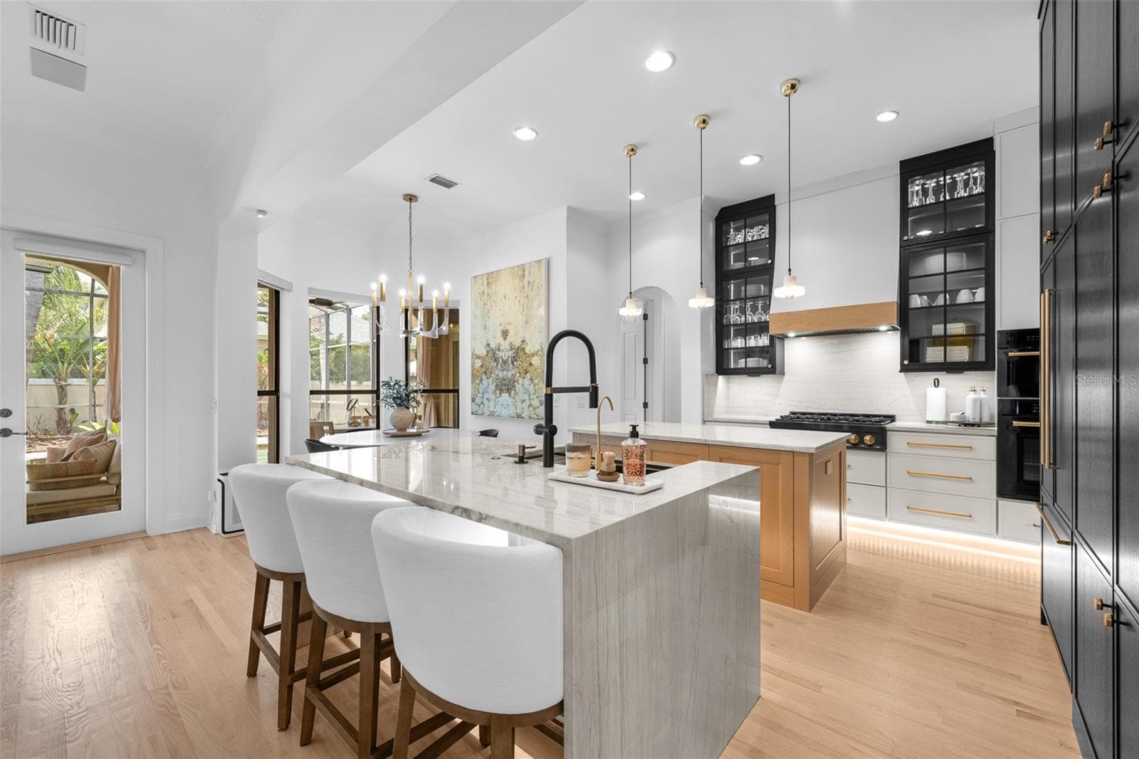Island seating for four, matte black faucet, and under-cabinet lighting. - 1921 FLORESTA VIEW DR, TAMPA