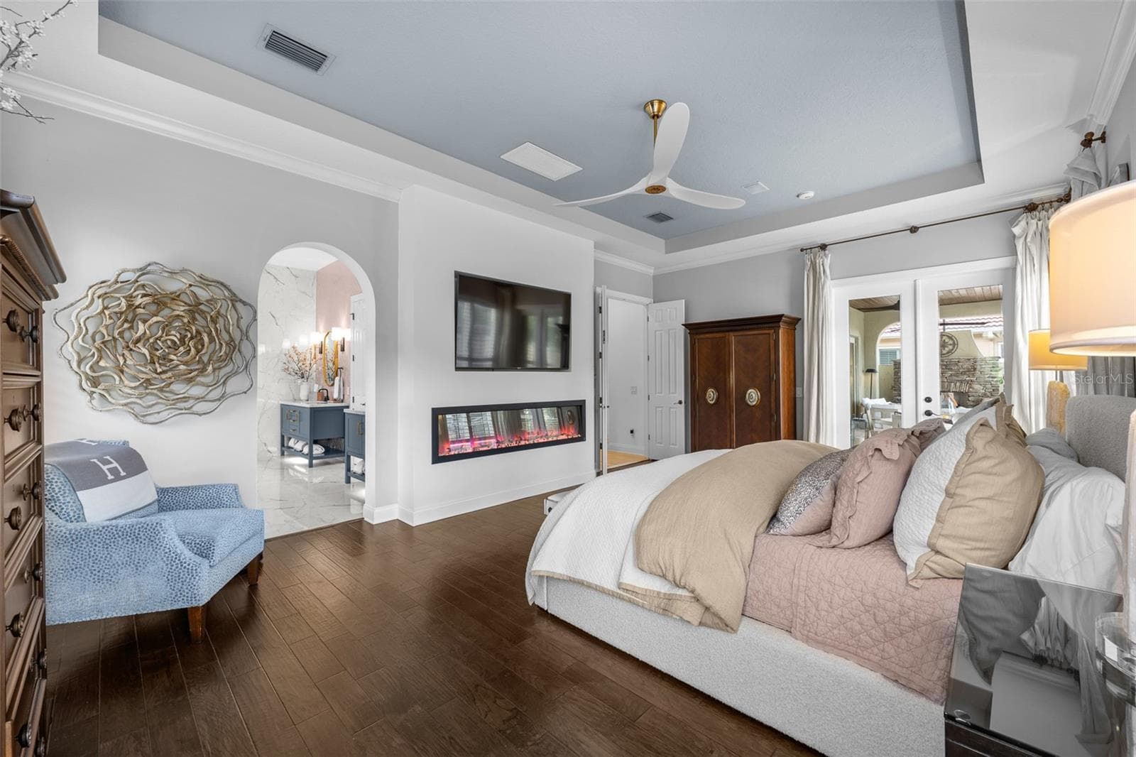 French doors, arched window, and linear electric fireplace. - 1921 FLORESTA VIEW DR, TAMPA