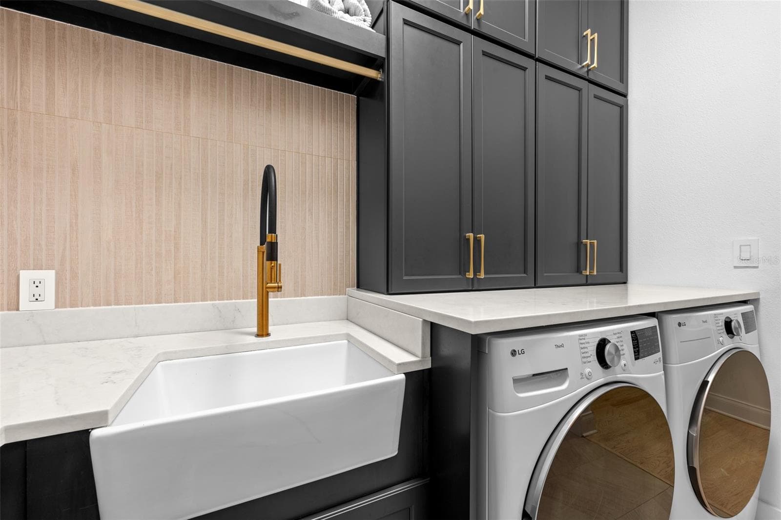 Laundry Room - Farmhouse utility sink with brass faucet, tile backsplash, and upper cabinet storage. - 1921 FLORESTA VIEW DR, TAMPA