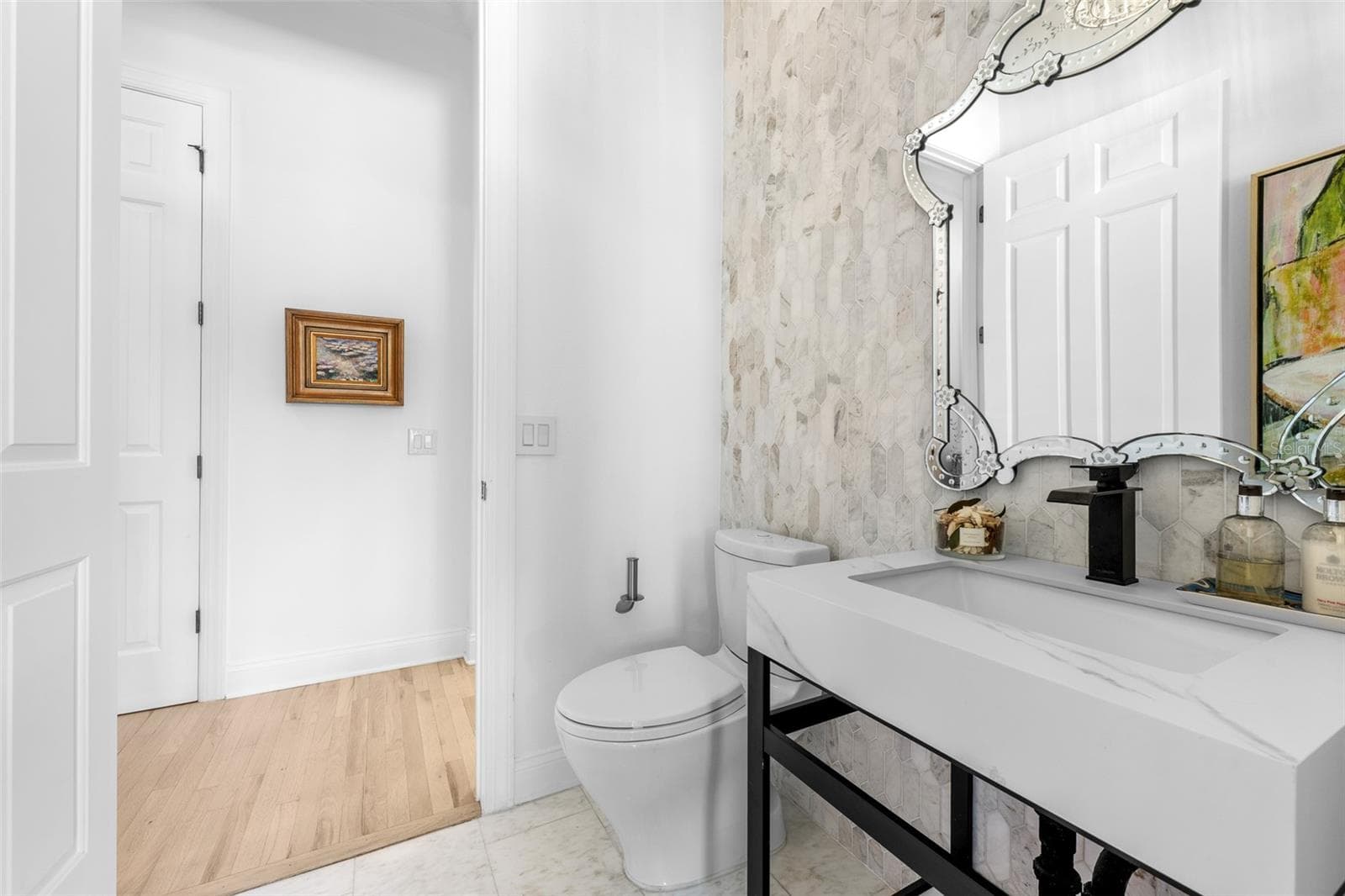 Pool bathroom — Console vanity with stone top and decorative mirror. - 1921 FLORESTA VIEW DR, TAMPA