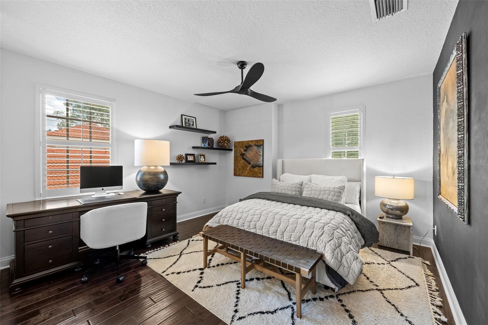 3rd Bedroom with desk area, floating wood shelves, and dark wood flooring. - 1921 FLORESTA VIEW DR, TAMPA