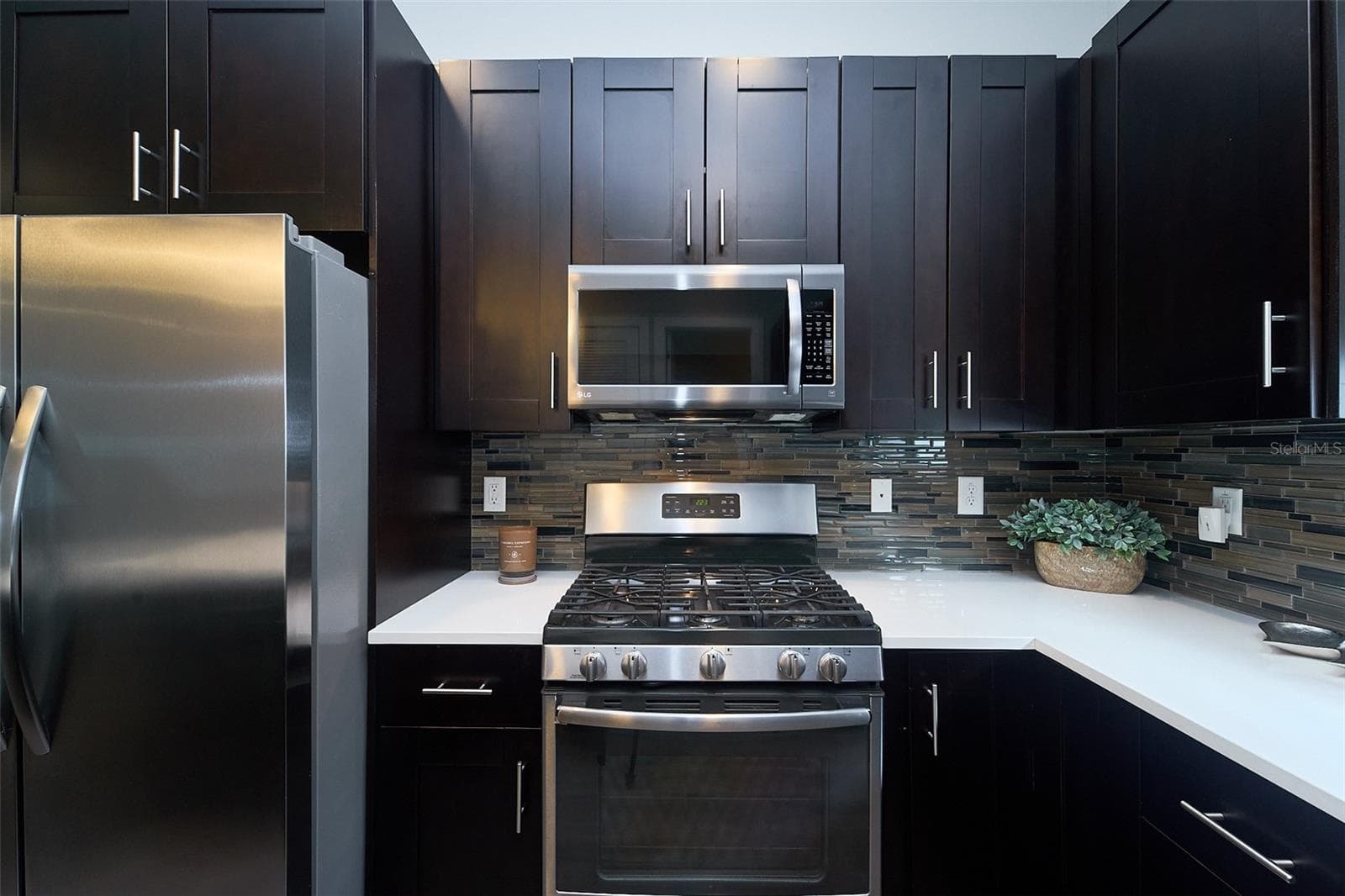 kitchen with dark cherry wood cabinets - 136 8TH ST N, ST PETERSBURG