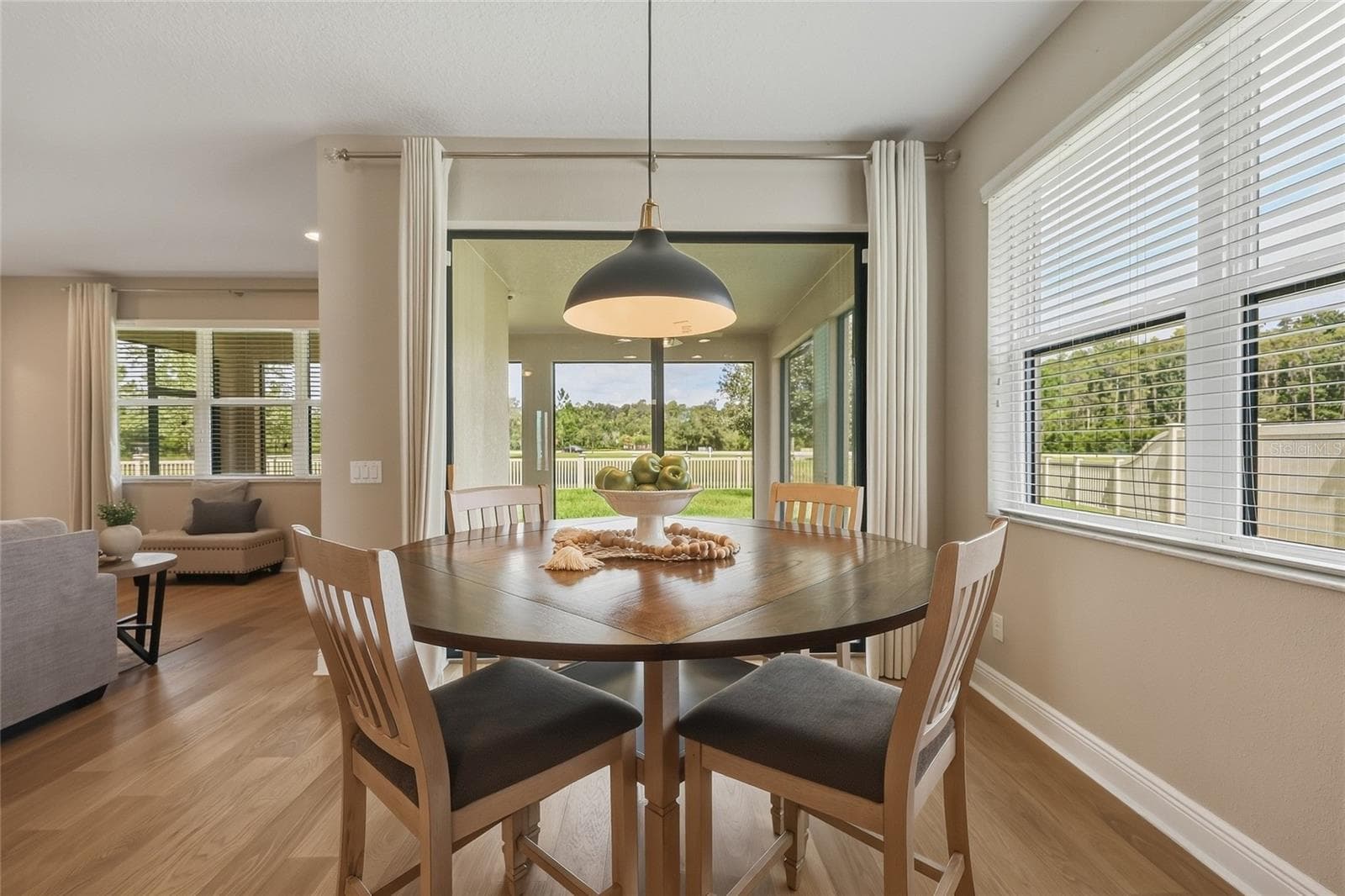 Light-filled eat-in kitchen with oversized window and sliding glass doors leading to the back patio - 10702 PLEASANT KNOLL DR, TAMPA