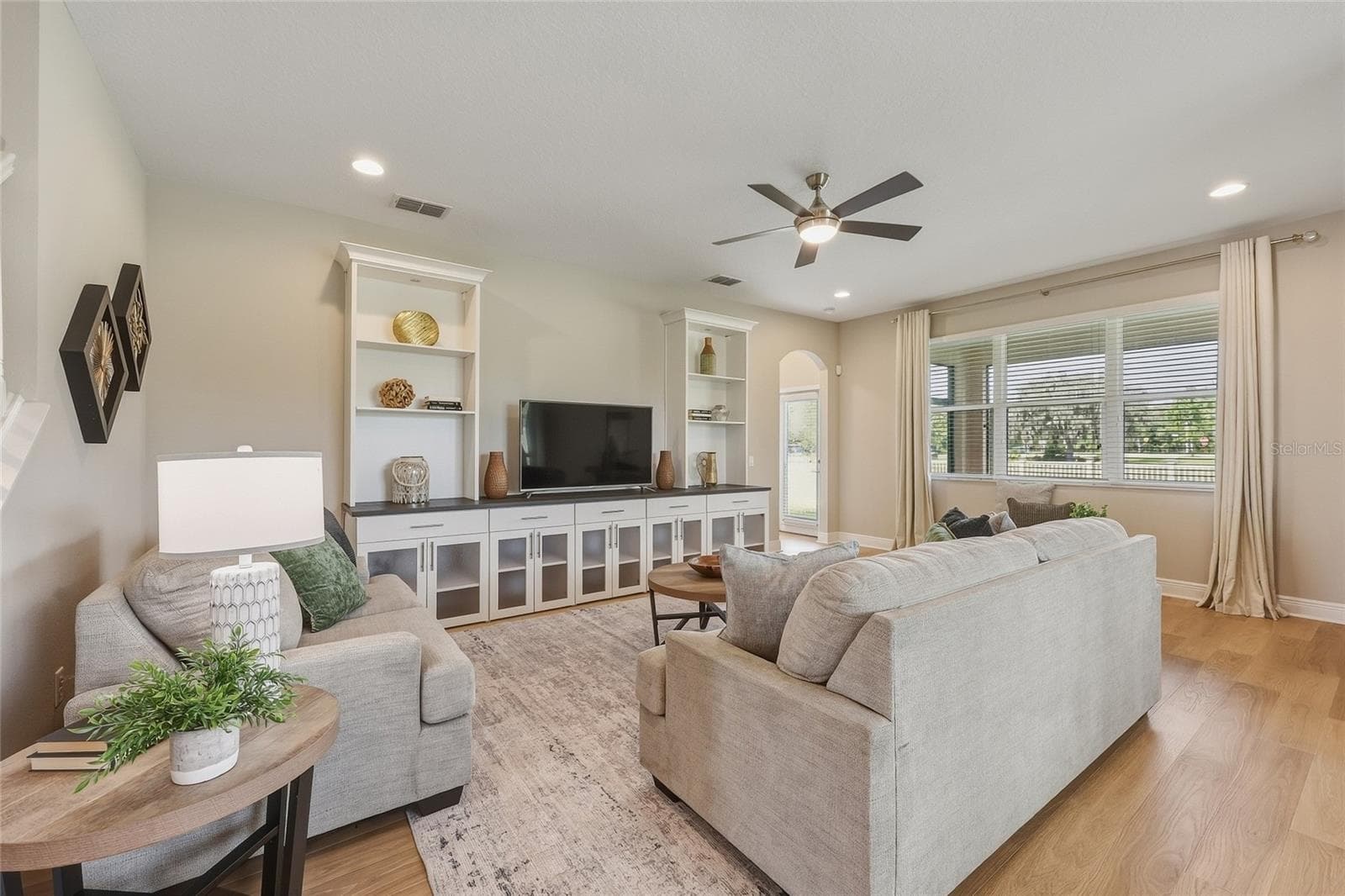 Living room featuring built-in cabinetry and shelving - 10702 PLEASANT KNOLL DR, TAMPA