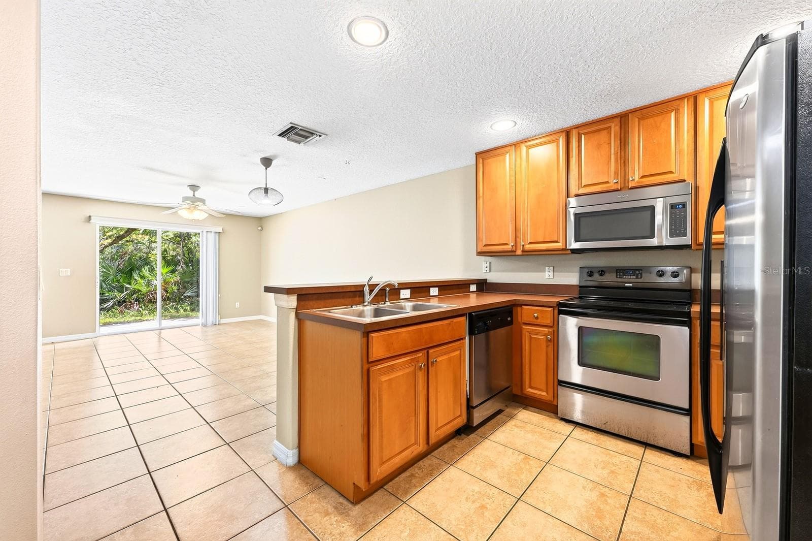 Kitchen is open to the living and dining areas. - 4559 LACEBARK TRL, OVIEDO