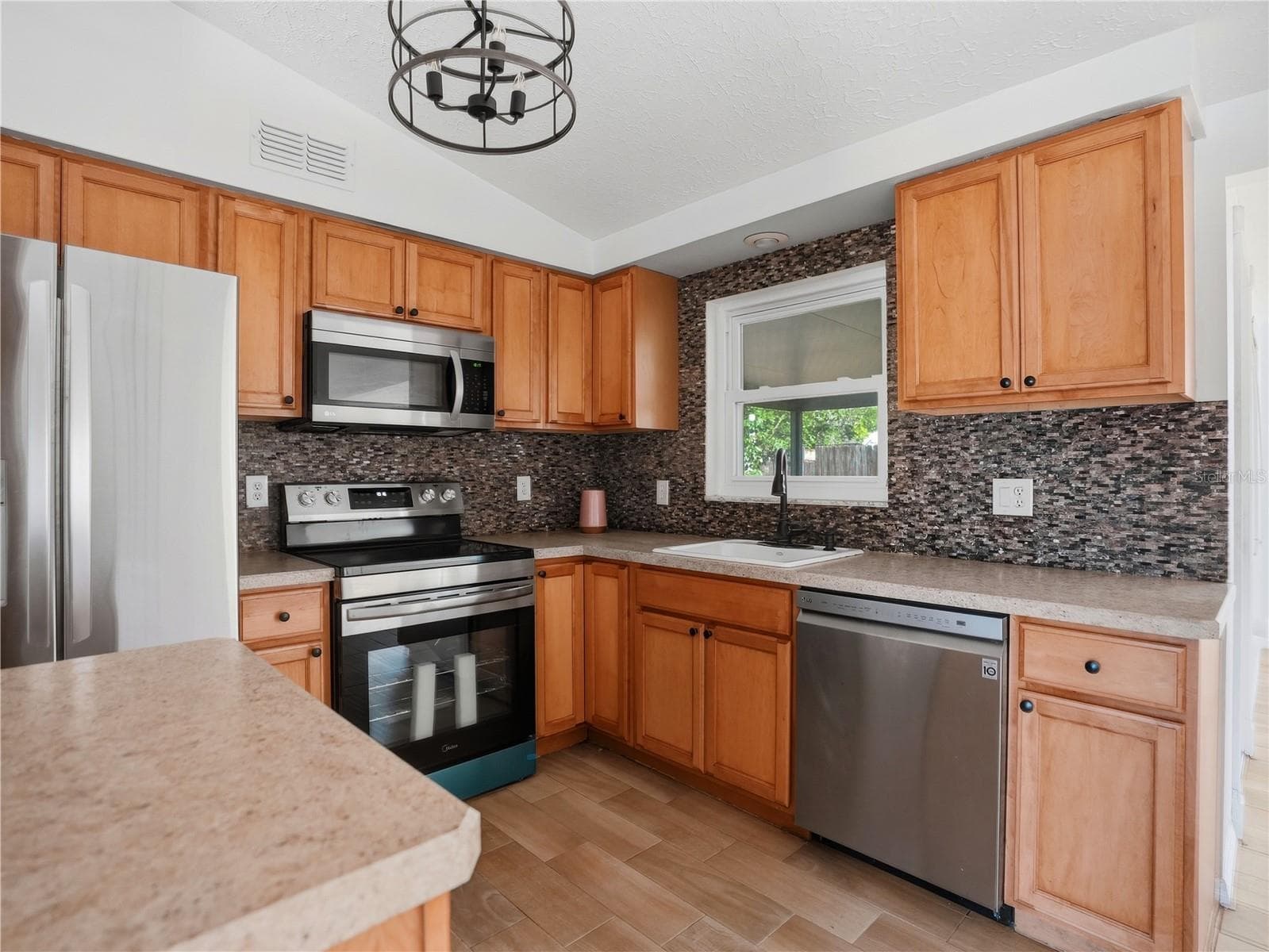 Kitchen with NEW appliances. - 6743 LARCHMONT AVE, NEW PORT RICHEY