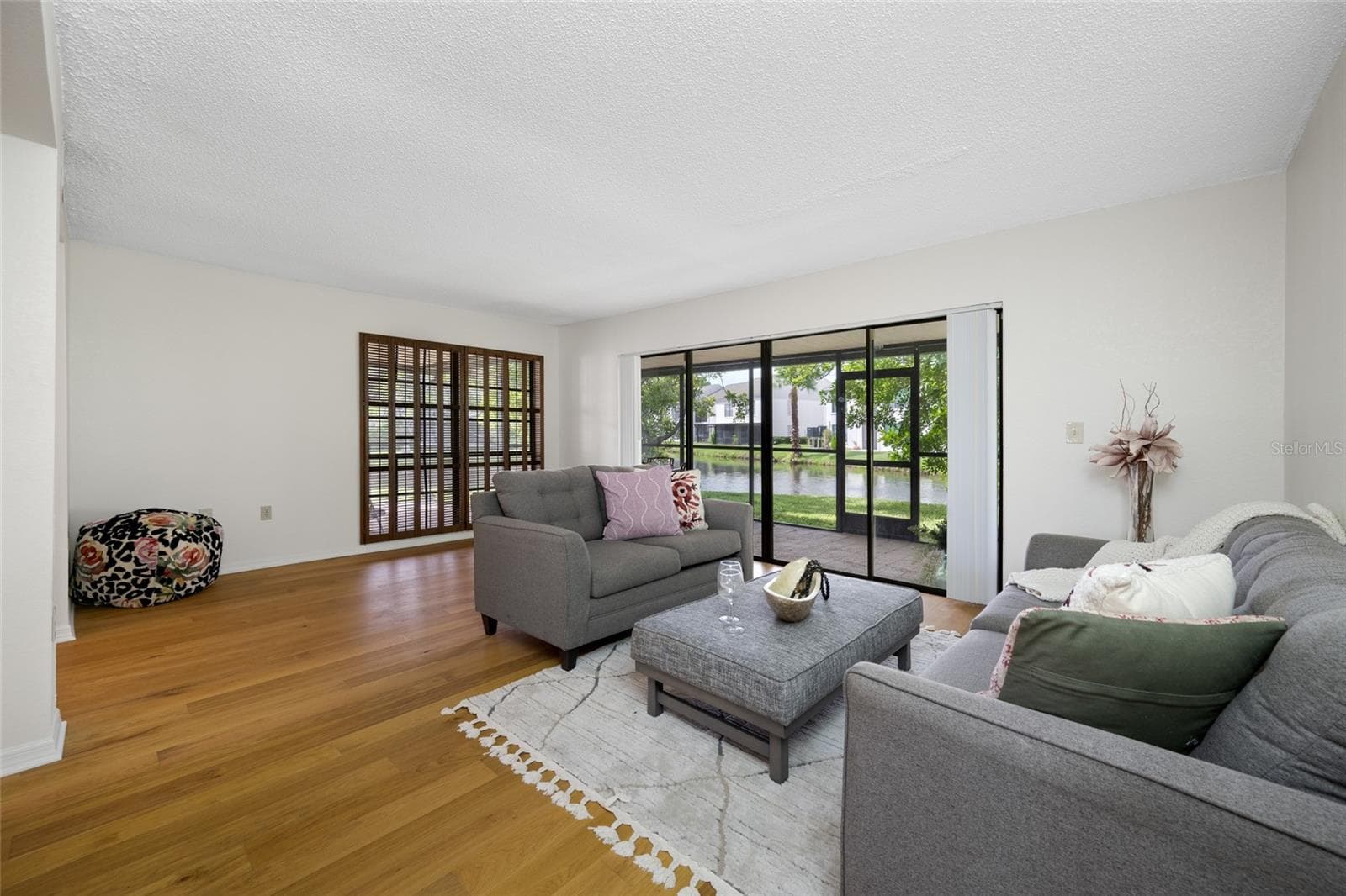 Sliding glass door lead you from the living room to the huge outdoor porch - 2467 KINGFISHER LN #101H, CLEARWATER