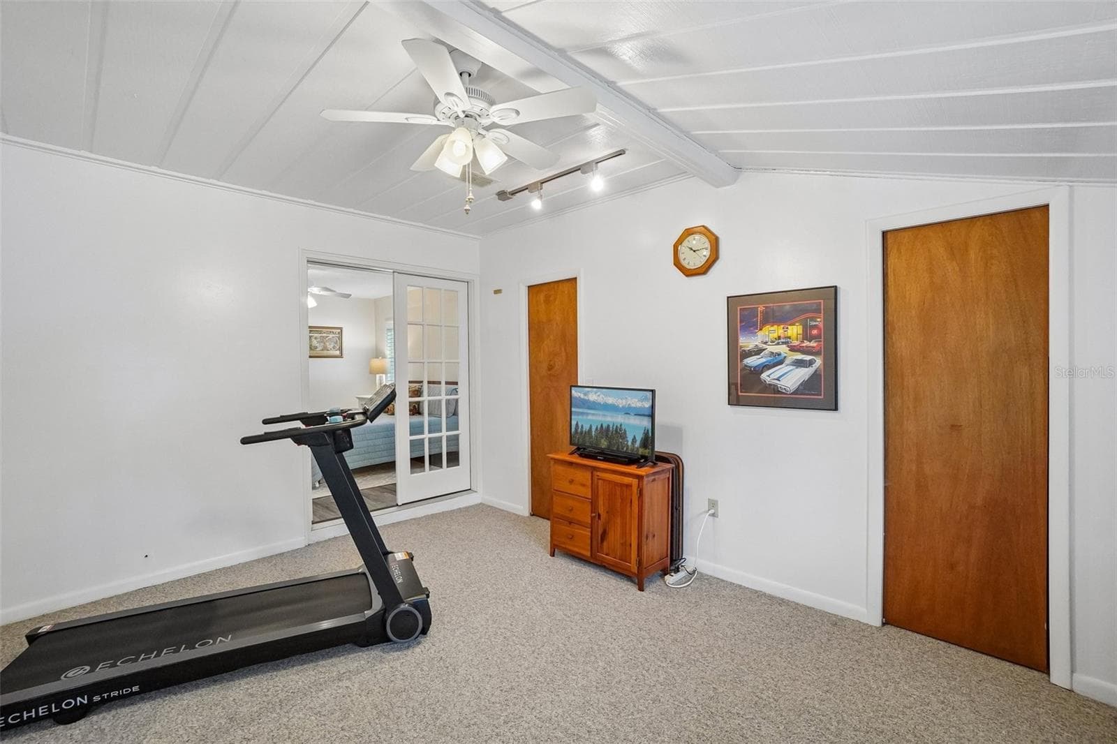 Bonus Room – Located just off the primary bedroom, this flexible bonus room offers carpeting, a ceiling fan, track lighting, and multiple storage closets—well suited for a home office, fitness area, hobby space, or private retreat. - 971 CORTLAND WAY, PALM HARBOR