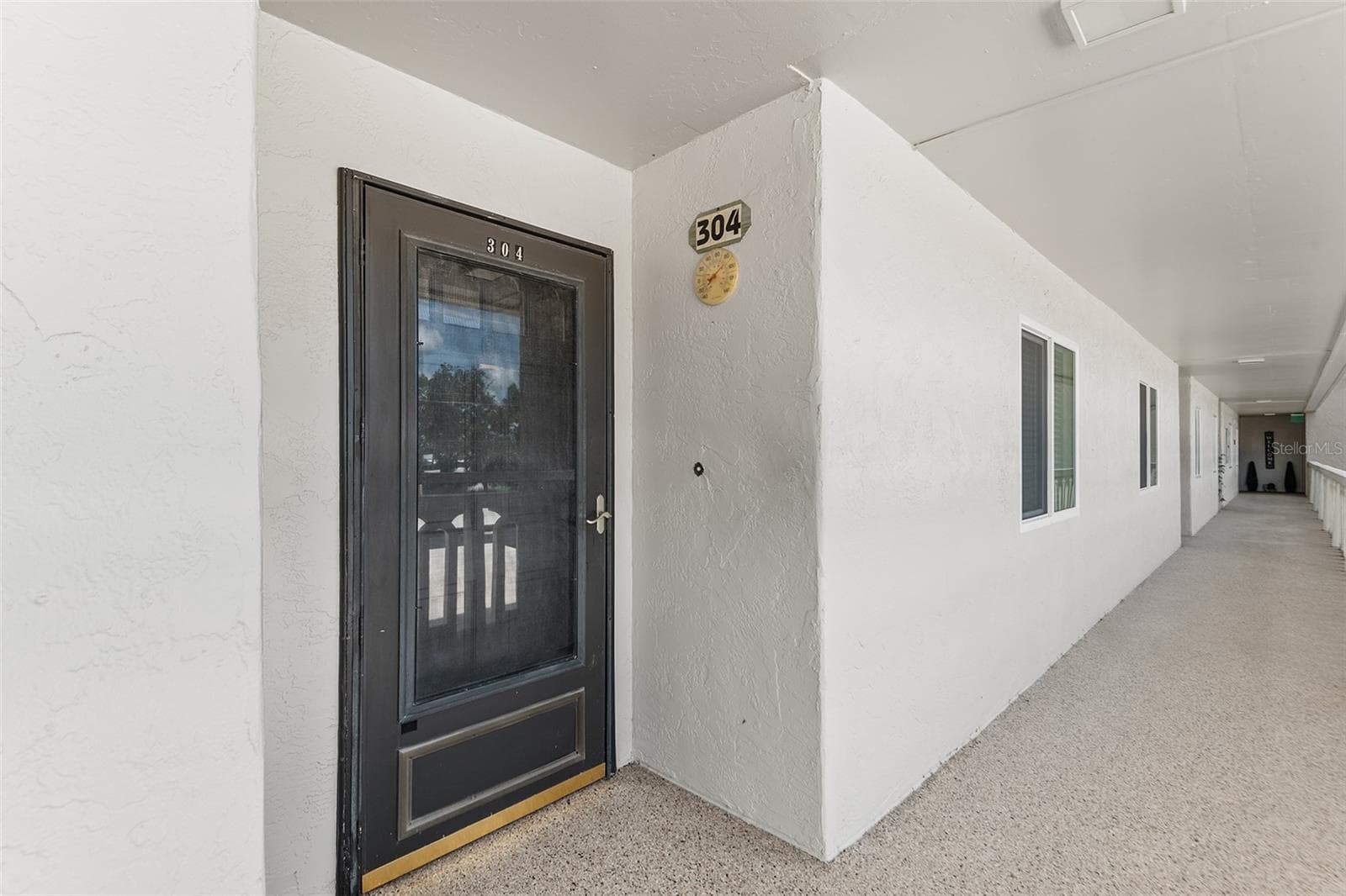 FRONT ENTRY OF UNIT. NOTE STORM DOOR. - 1776 6TH ST NW #304, WINTER HAVEN