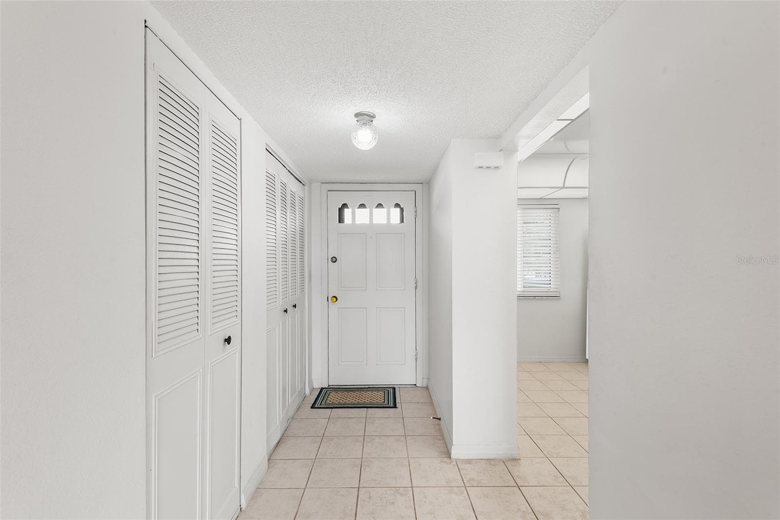 VIEW TOWARDS FRONT ENTRY FOYER. CLOSET STORAGE ON LEFT. ENTRY TO KITCHEN ON THE RIGHT. - 1776 6TH ST NW #304, WINTER HAVEN