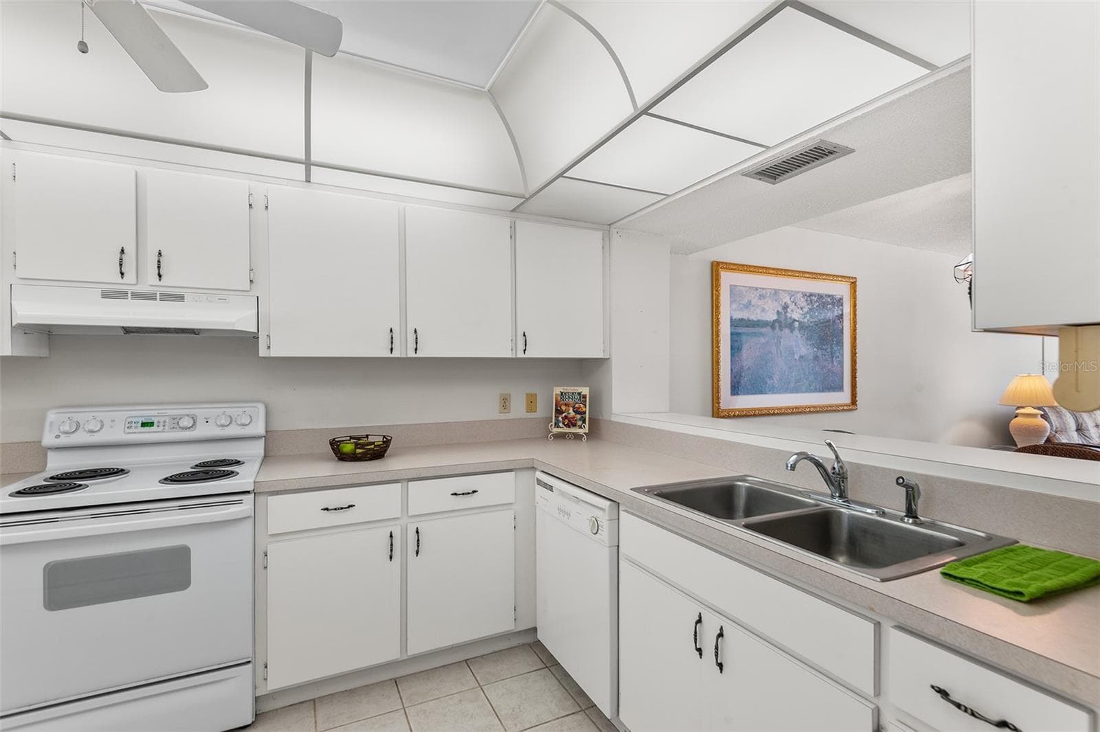 KITHEN WITH PASS THRU TO DINING AREA - 1776 6TH ST NW #304, WINTER HAVEN