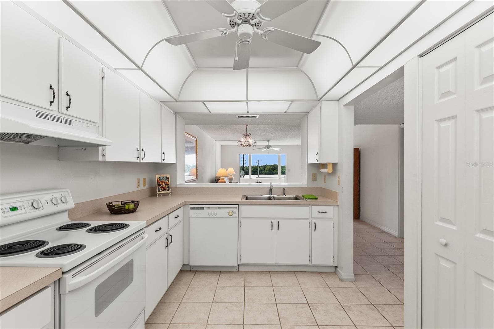 KITCHEN WITH PASS THRU TO DINING AREA. PANTRY CLOSET ON RIGHT. - 1776 6TH ST NW #304, WINTER HAVEN