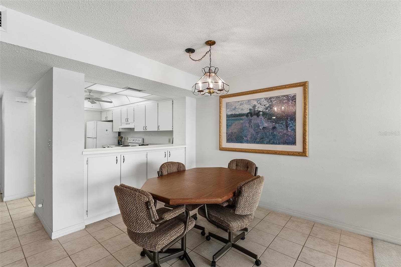 DINING AREA. NOTE EXTRA CABINET STORAGE BELOW PASS THRU FROM KITCHEN - 1776 6TH ST NW #304, WINTER HAVEN