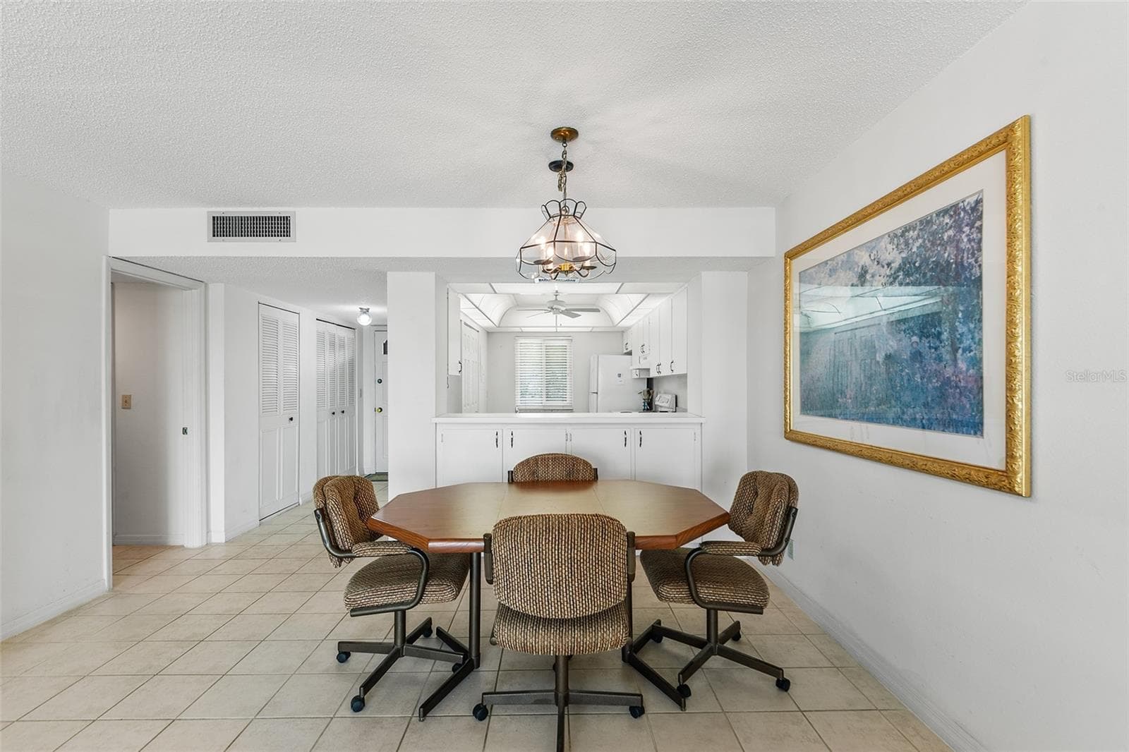 VIEW TOWARDS DINING AREA, KITCHEN, FRONT ENTRY CLOSET STORAGE - 1776 6TH ST NW #304, WINTER HAVEN
