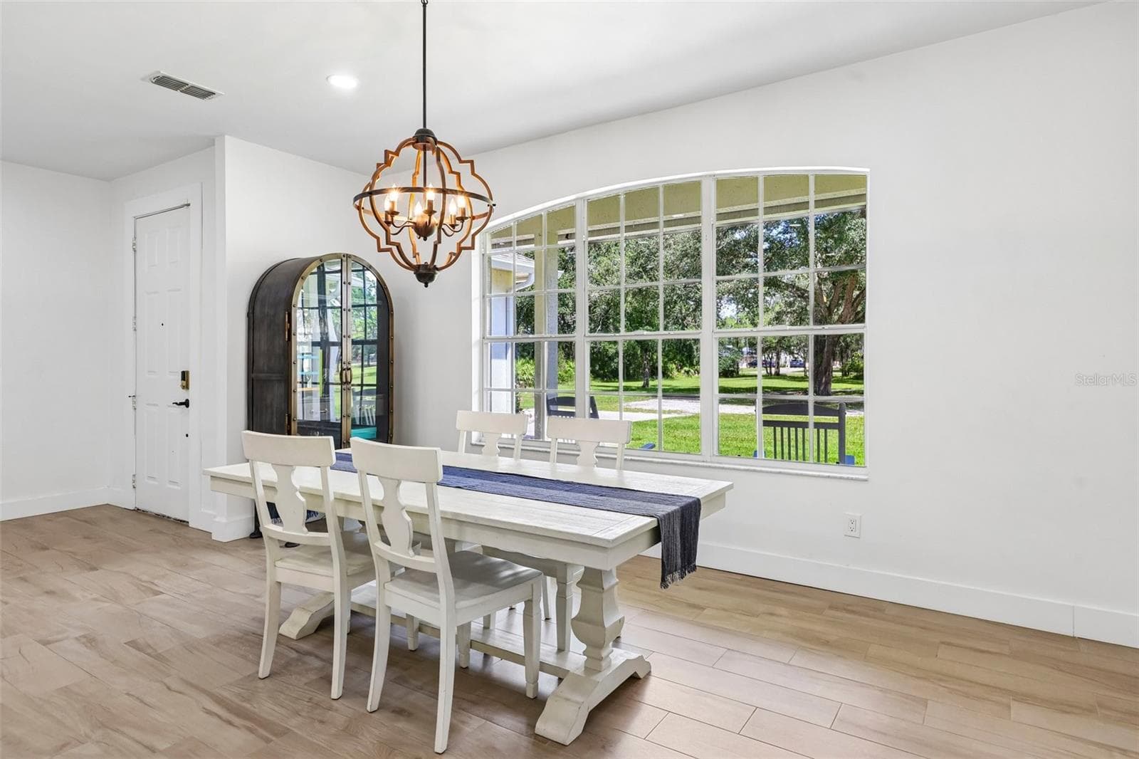 The nearby BRIGHT AND SUNNY Dining Area is highlighted by a LARGE PICTURE WINDOW overlooking the front yard. - 19106 SHELDON ST, ORLANDO