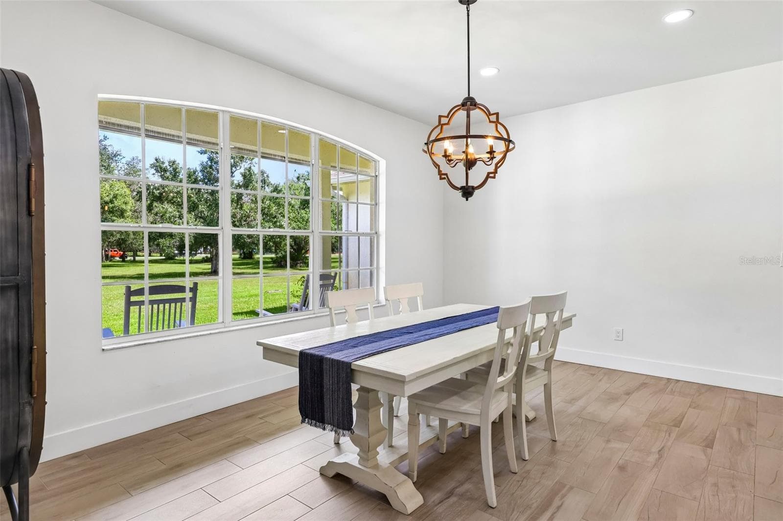 The nearby BRIGHT AND SUNNY Dining Area is highlighted by a LARGE PICTURE WINDOW overlooking the front yard. - 19106 SHELDON ST, ORLANDO