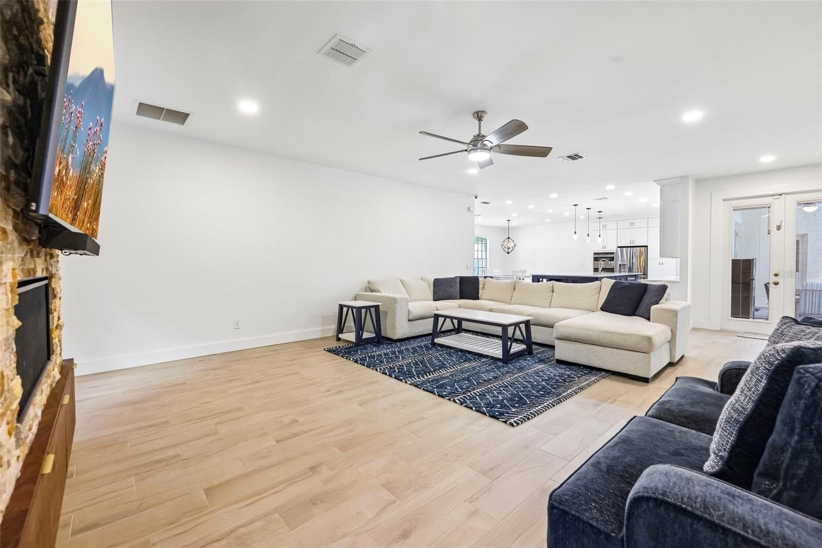 Glass-paneled doors open to the patio and pool, bringing in natural light and making it easy to move between indoor and outdoor living. - 19106 SHELDON ST, ORLANDO
