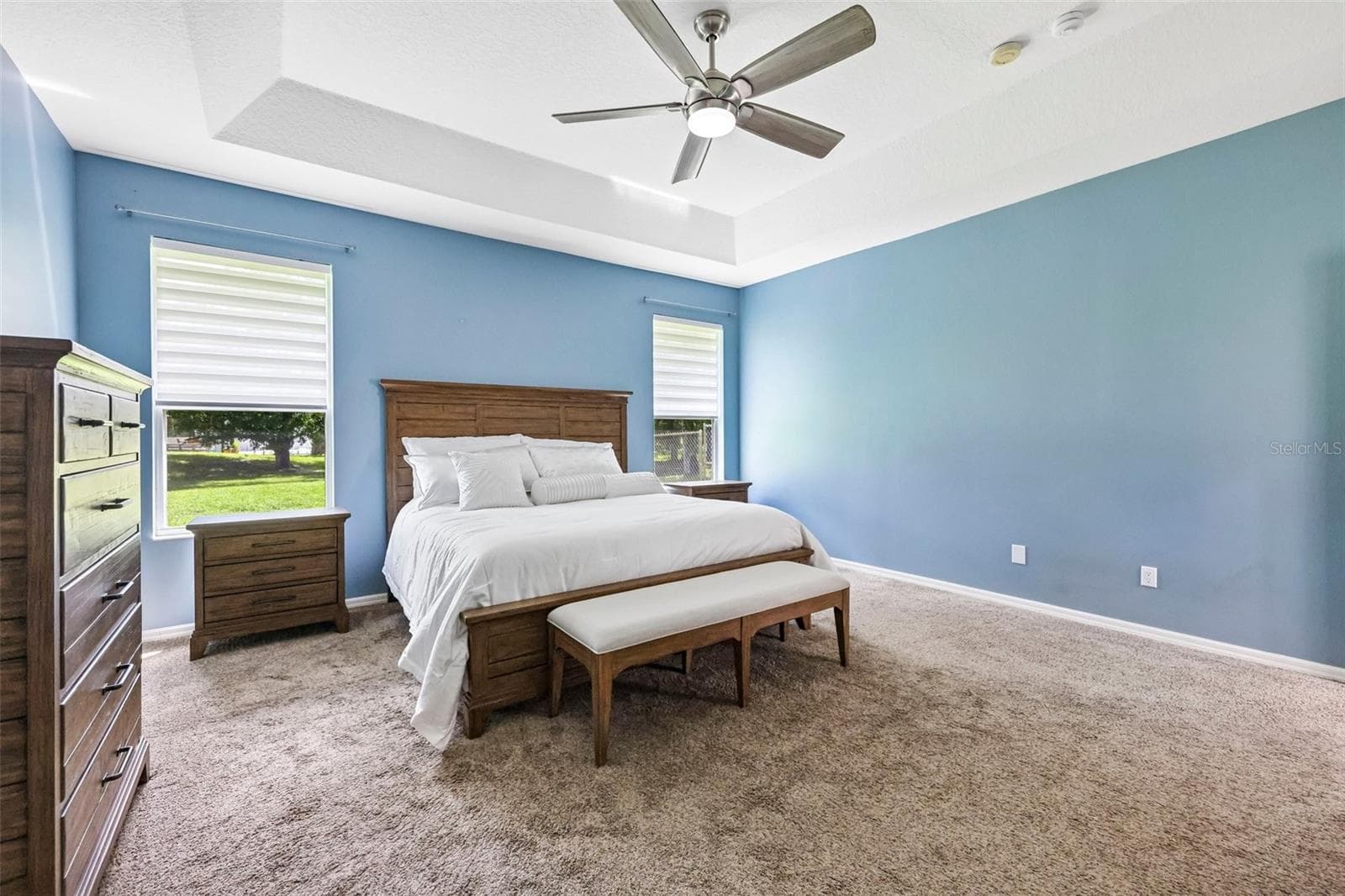The carpeted Primary Suite features a TRAY CEILING, DUAL CLOSETS and a spacious en-suite bath designed with a spa-like feel. - 19106 SHELDON ST, ORLANDO