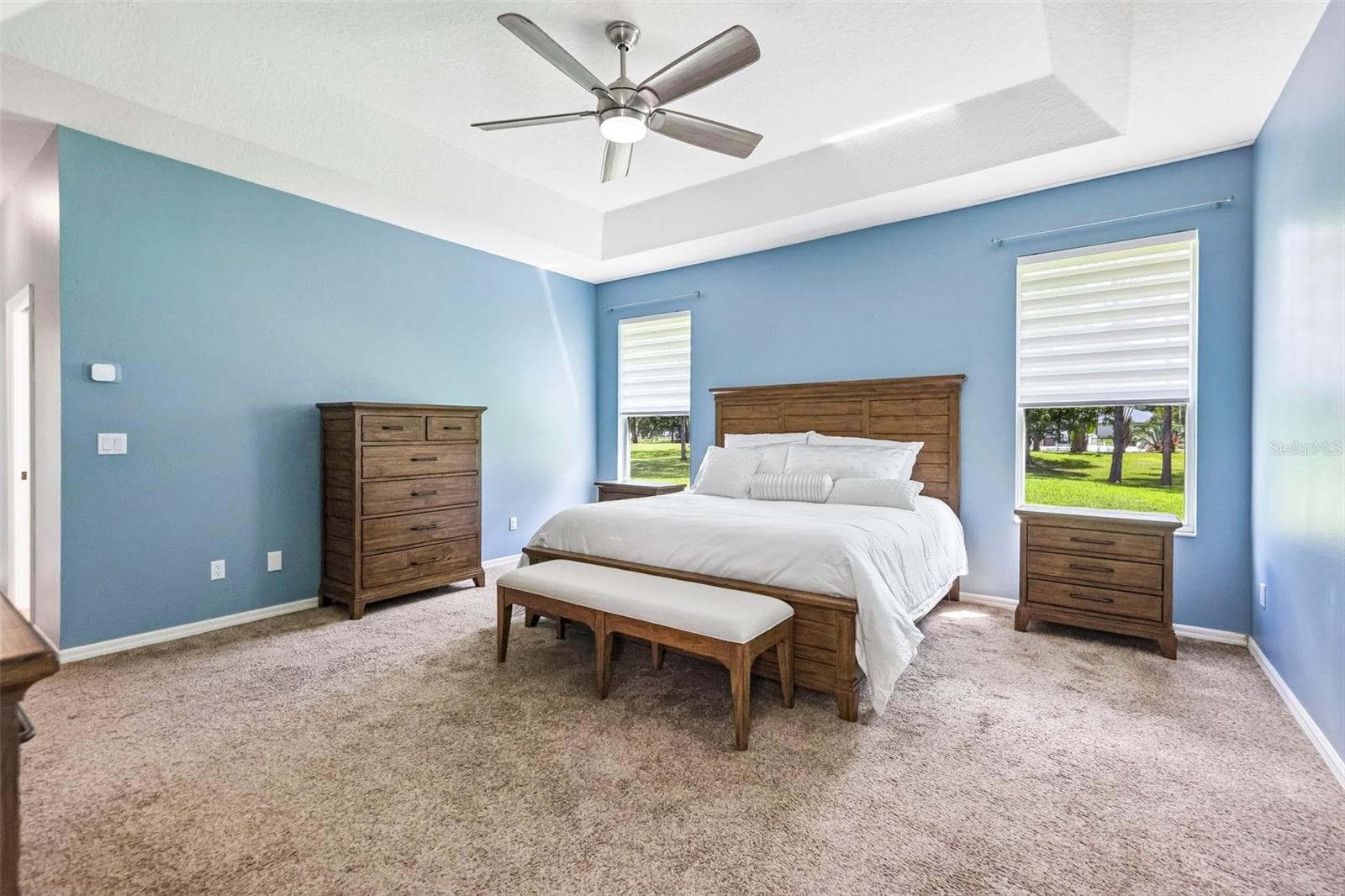 The carpeted Primary Suite features a TRAY CEILING, DUAL CLOSETS and a spacious en-suite bath designed with a spa-like feel. - 19106 SHELDON ST, ORLANDO