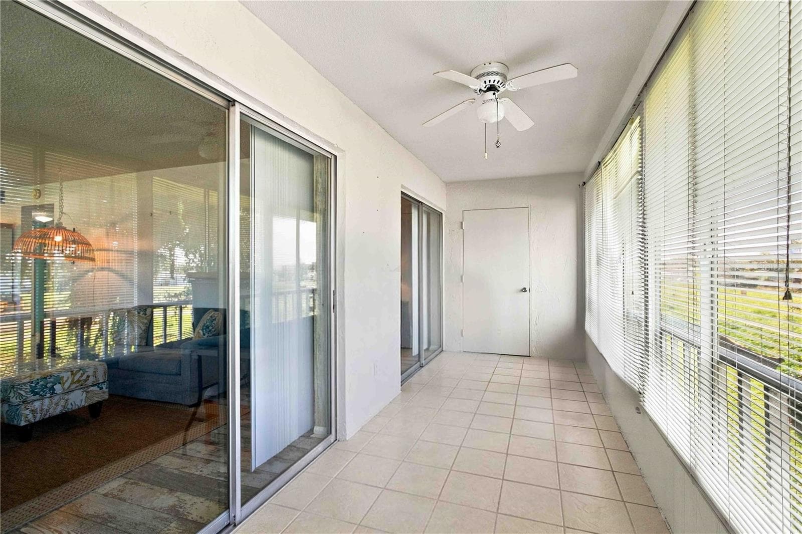 Large rear balcony, enclosed. Some storage totes were removed from the image. - 304 47TH AVENUE DR W #313, BRADENTON