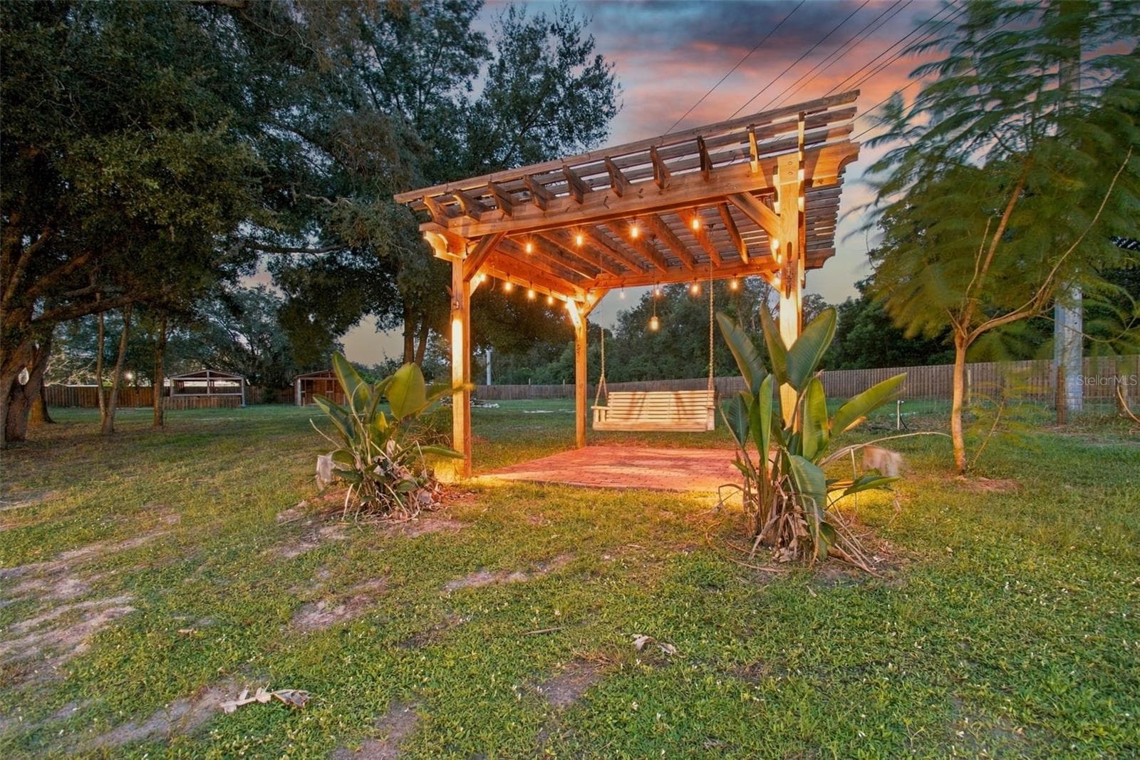 THAT PERGOLA IS SO INVITING AT DUSK - 14122 CHESTERFIELD TRL, HUDSON