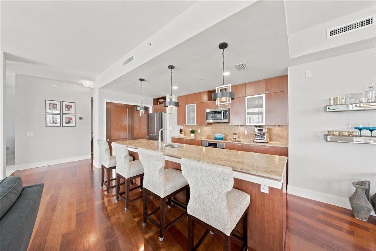 Durable granite surfaces provide generous workspace and an elevated finish. - 111 N 12TH ST #1704, TAMPA