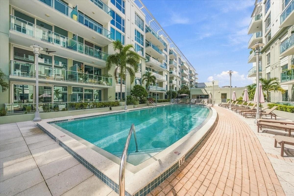 Beautifully landscaped pool area features lounge seating and umbrella tables. - 111 N 12TH ST #1704, TAMPA