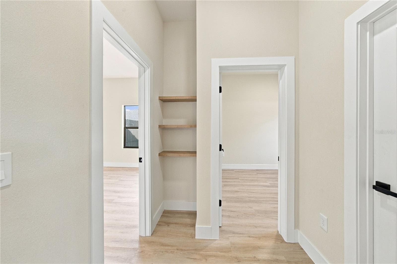 Hallway & Bookshelves between Bedrooms - 7511 BLUTTER RD, NORTH PORT