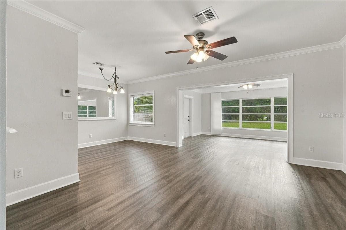 Living Room Looking to Sunroom and Dining Room - 950 14TH ST NE, WINTER HAVEN