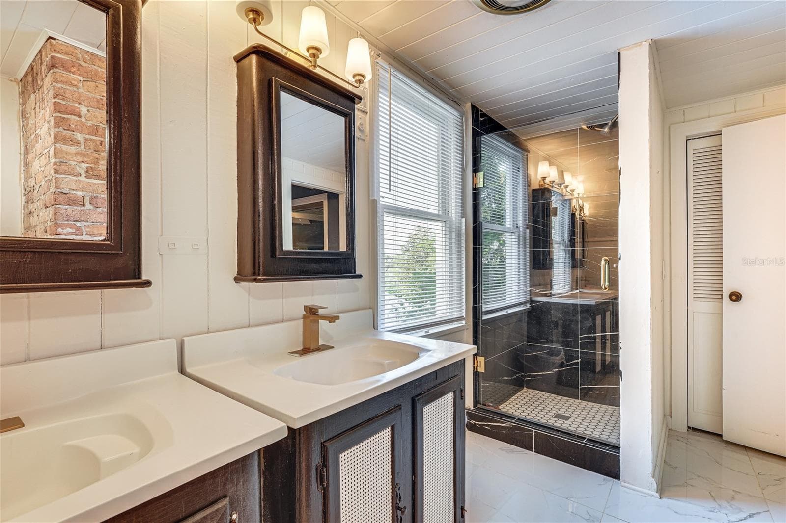 Updated Bathroom with Double Vanity and Exposed Brick - 743 E FORT KING ST, OCALA