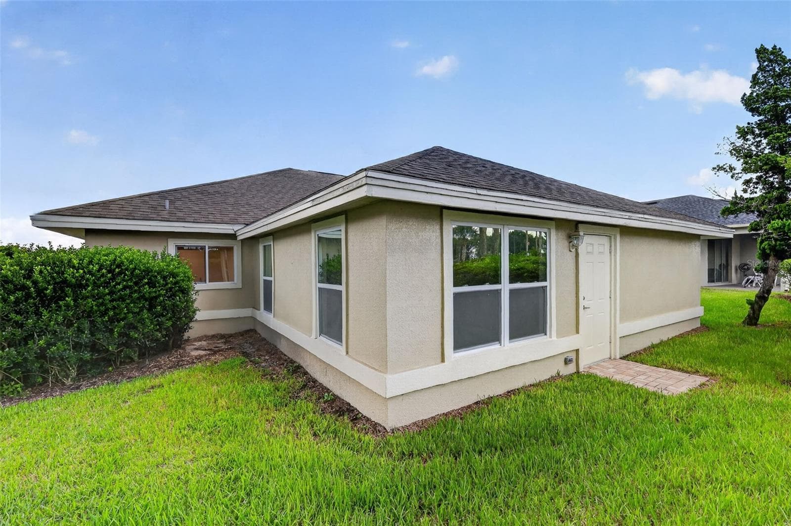 BACK OF HOME WITH ENTRY TO PRIMARY BEDROOM - 11041 SE 174TH LOOP, SUMMERFIELD
