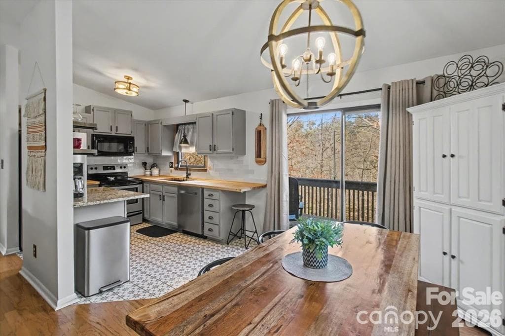 Kitchen with access to expansive upper deck - 30 Whippoorwill Drive, Weaverville