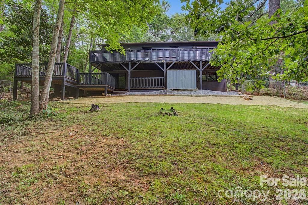 Back of the home with fresh gravel, new french drain and grass seed. - 30 Whippoorwill Drive, Weaverville