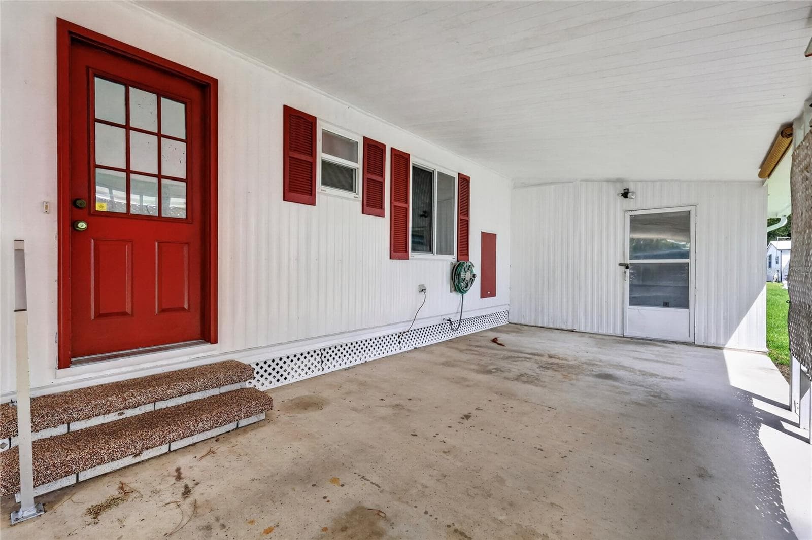 Full roof over car port - 210 PALM MEADOWS DR, EUSTIS