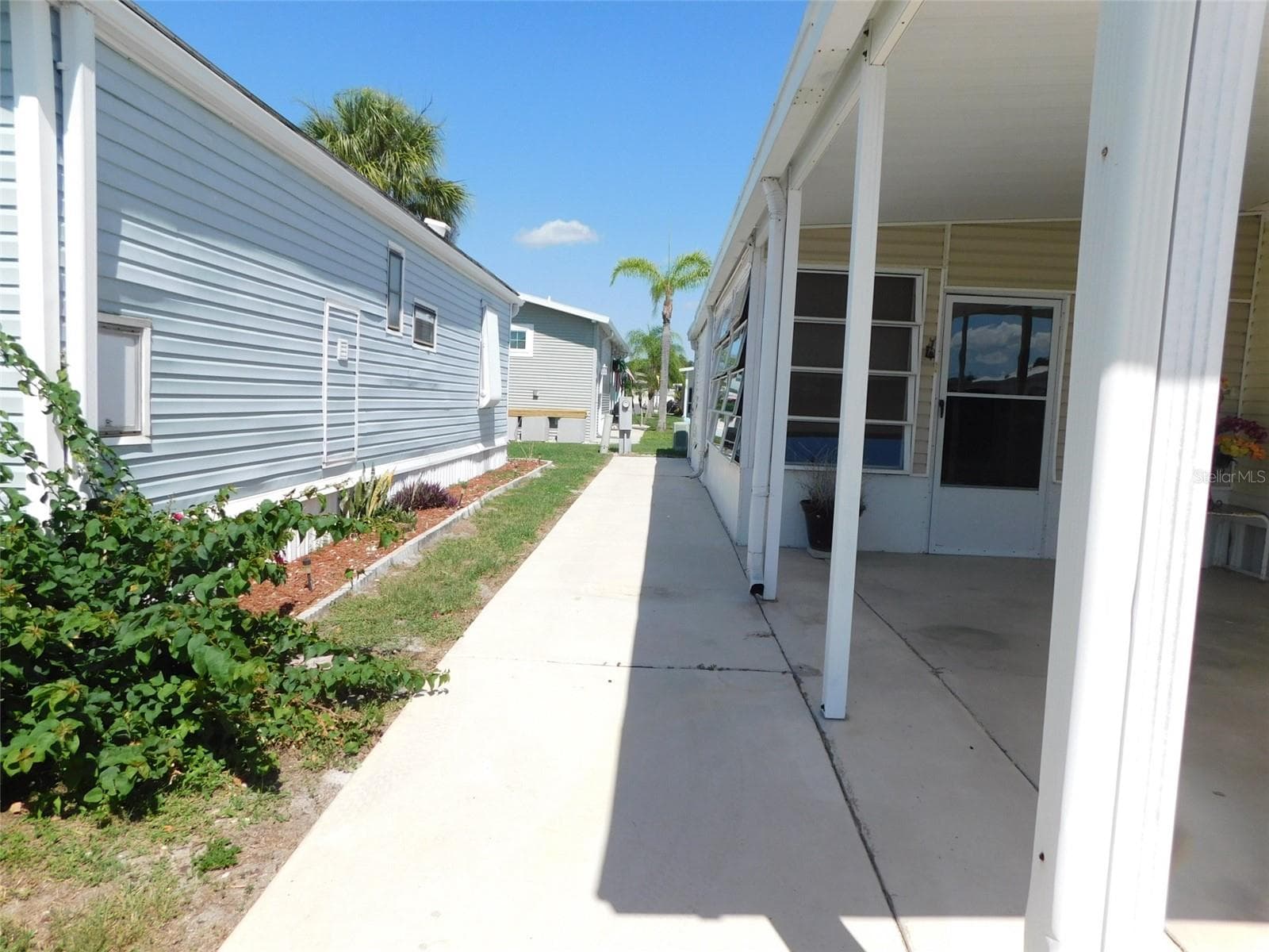 SIDEWALK TO THE UTILITY/LAUNDRY ROOM - 7739 BLUFF BLVD #121, ZOLFO SPRINGS