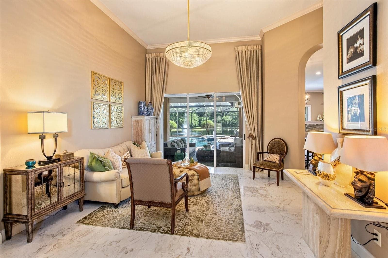Living Room soaring ceilings and view to pool, pond and lanai - 1220 PRESTIGE PT, OVIEDO