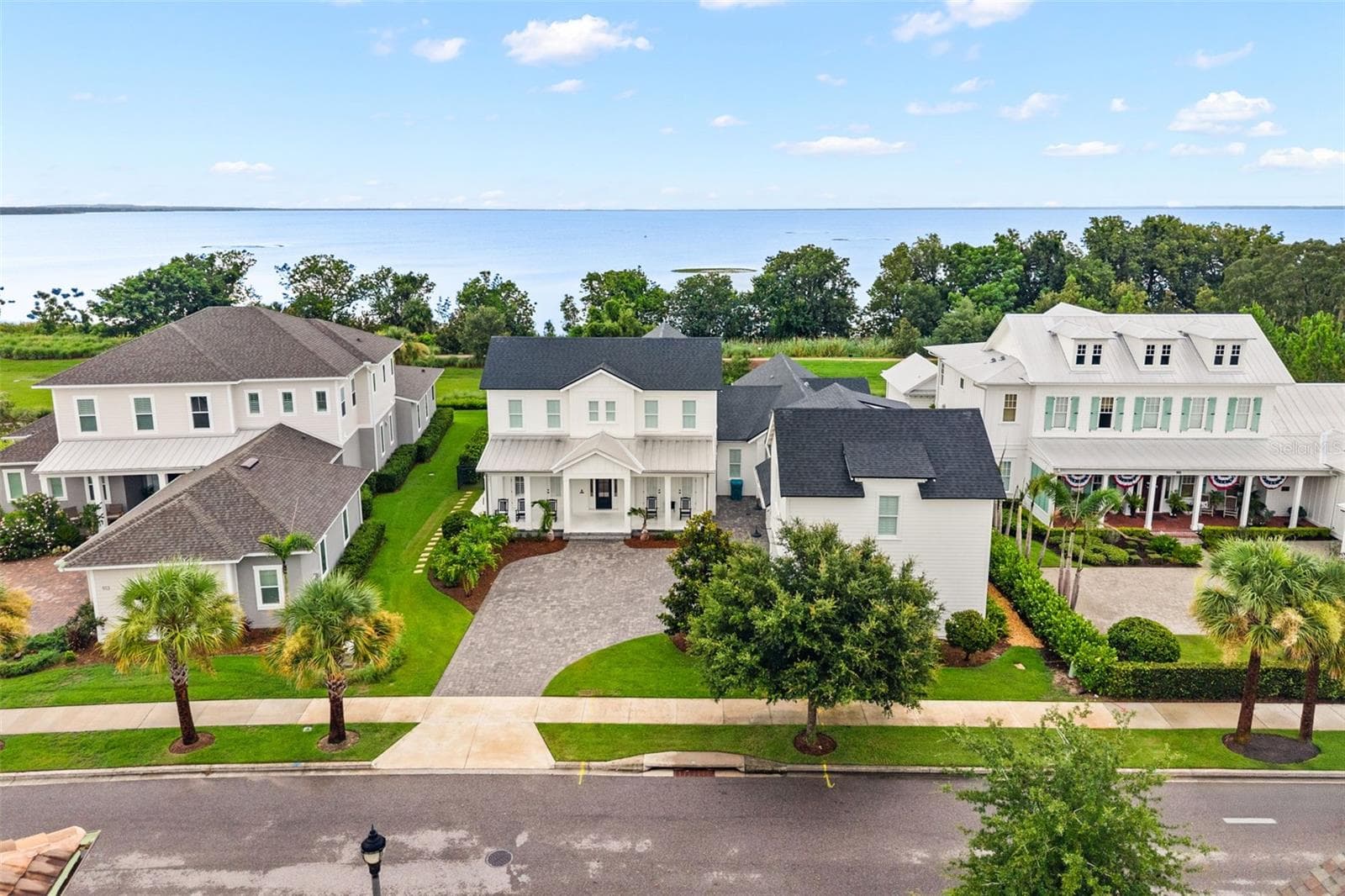 CONSERVATION + LAKE APOPKA BEYONDThe aerial view shows the home’s relationship to the conservation landscape, with Lake Apopka beyond and no immediate rear homes directly behind the property. - 907 CELADON ST, WINTER GARDEN