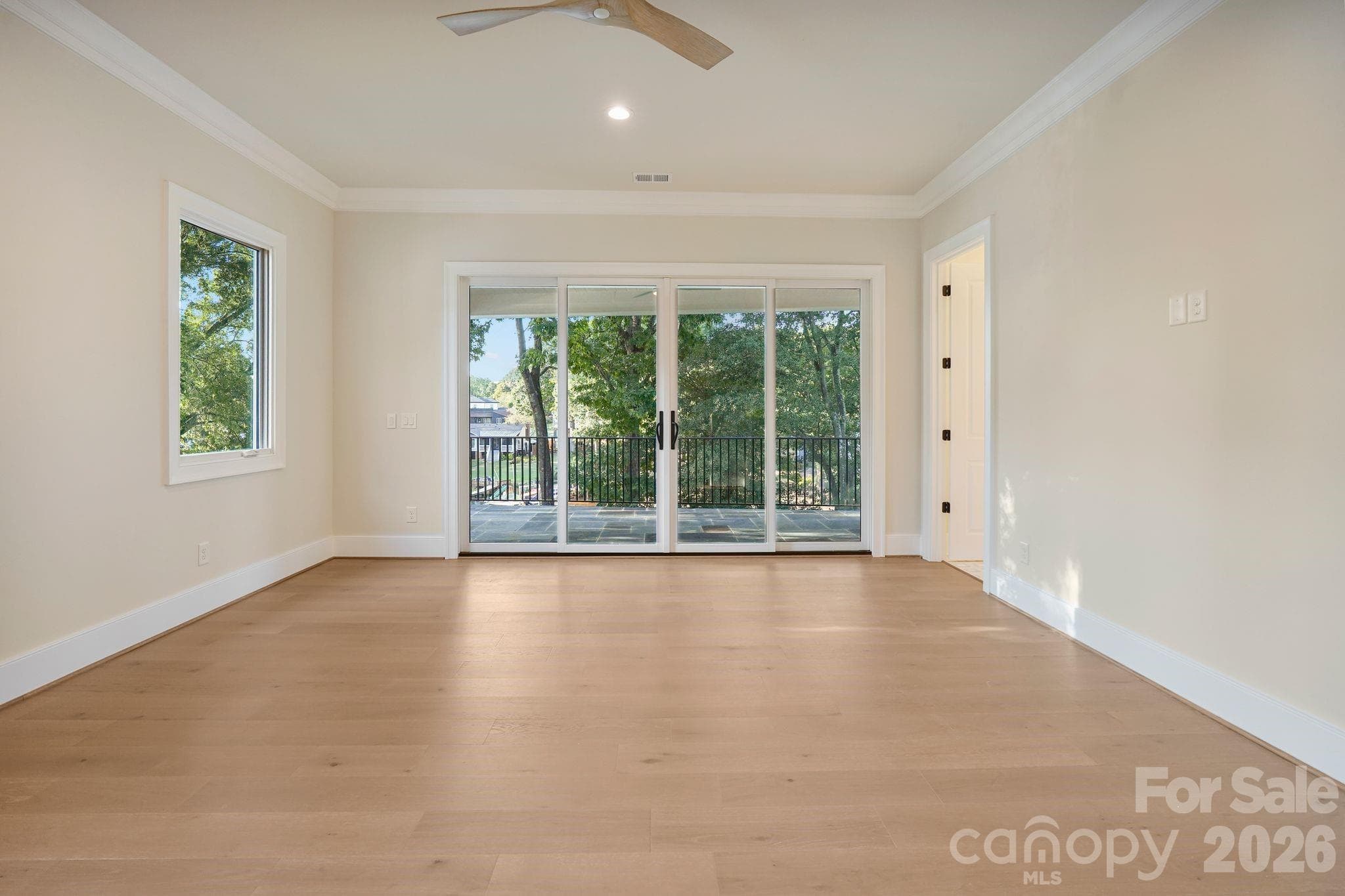 Spacious primary bedroom featuring 10' ceilings and a bright, open feel, creating a comfortable and refined private retreat. - 21216 Rio Oro Drive, Cornelius