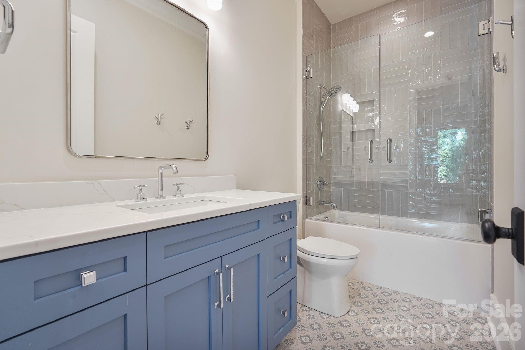 Beautifully finished upstairs shared bath featuring a full-size tub with a custom tile surround and elevated finishes throughout. - 21216 Rio Oro Drive, Cornelius