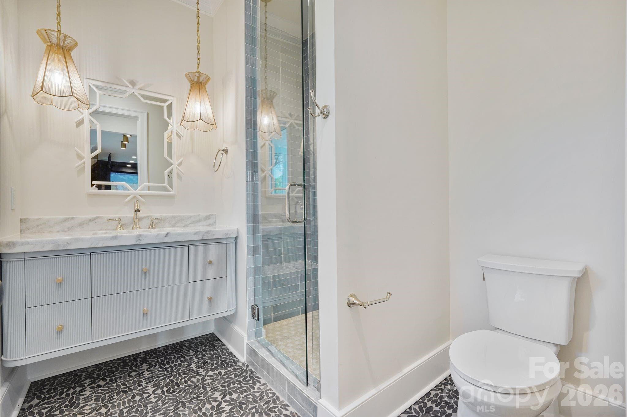 Thoughtfully designed basement bath provides convenient access from the outdoor living areas, helping keep wet traffic contained on the lower level, with a dedicated laundry room located just steps away. - 21216 Rio Oro Drive, Cornelius
