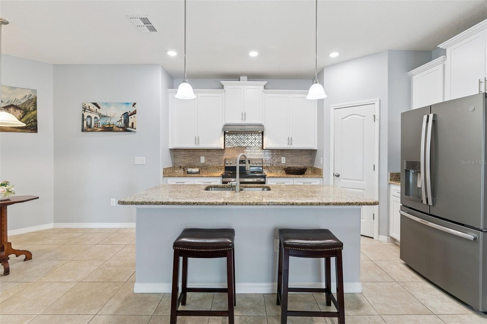 The center island embellished with granite countertops and pendant lighting - 3541 RALEIGH DR, WINTER HAVEN