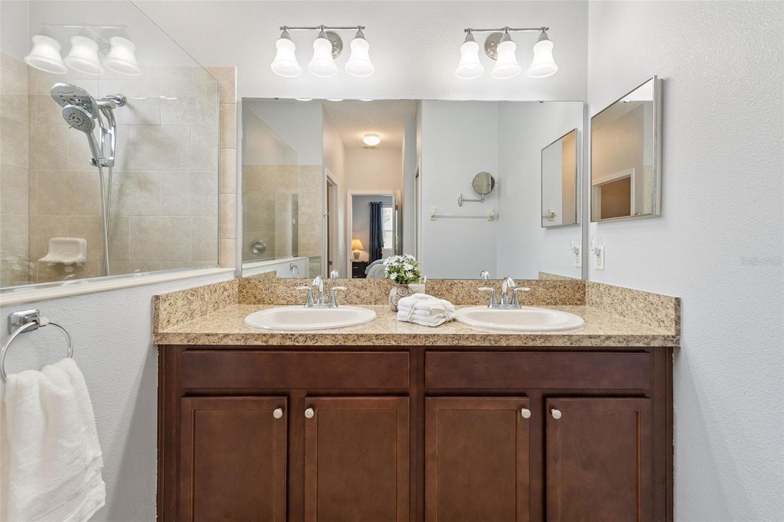 Primary Bath features a comfort height vanity with dual sinks, linen closet and a water closet - 3541 RALEIGH DR, WINTER HAVEN