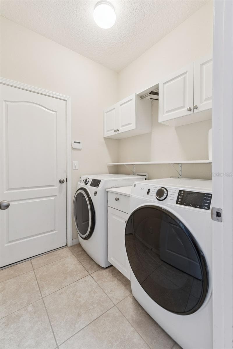 Laundry Room features cabinetry and upgraded Washer & Dryer - 3541 RALEIGH DR, WINTER HAVEN