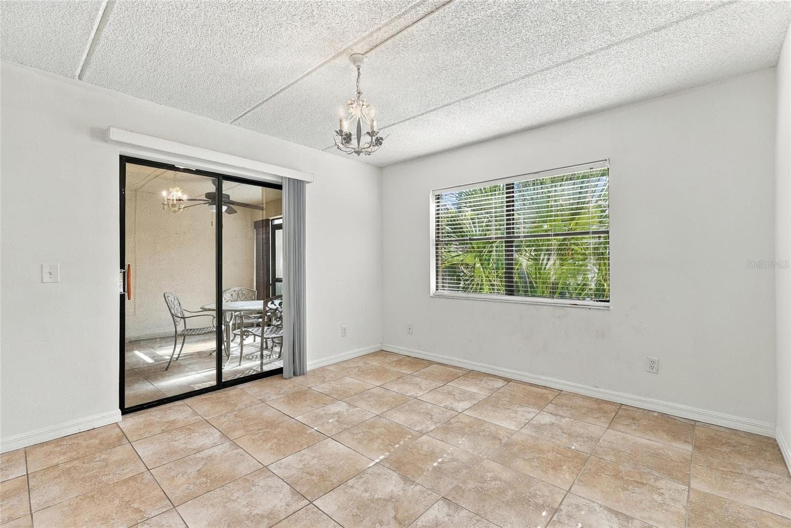 Primary Bedroom with Sliders to Back Patio - 131 WOODLAKE WYNDE, OLDSMAR