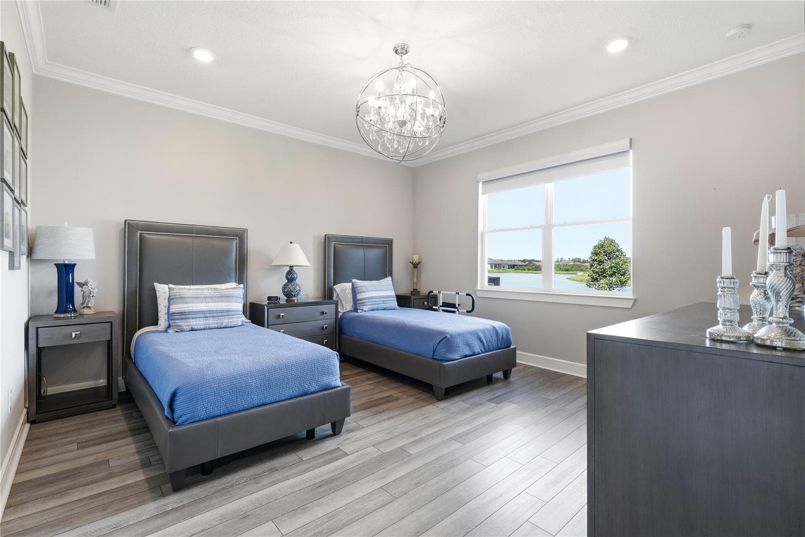 Primary Bedroom with a water view and a gorgeous chandelier. - 5535 BLUE CRUSH BND, LAND O LAKES